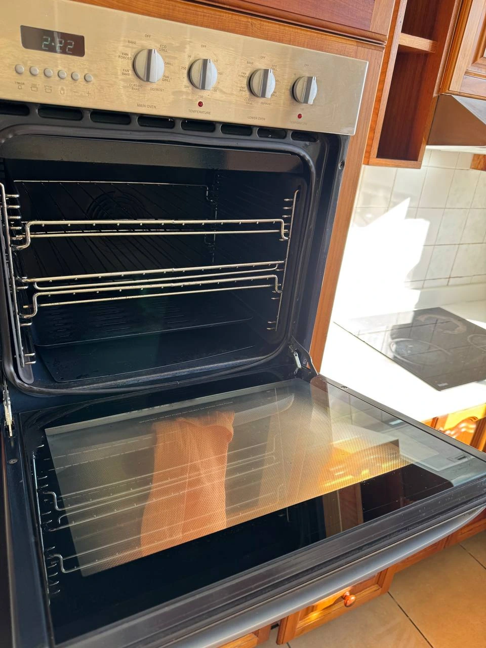 Clean and sparkling wall oven interior with racks after professional deep clean — after