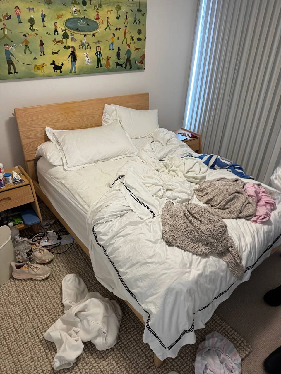 Before professional bed making service showing an unmade bed with messy bedding in a residential bedroom. — before