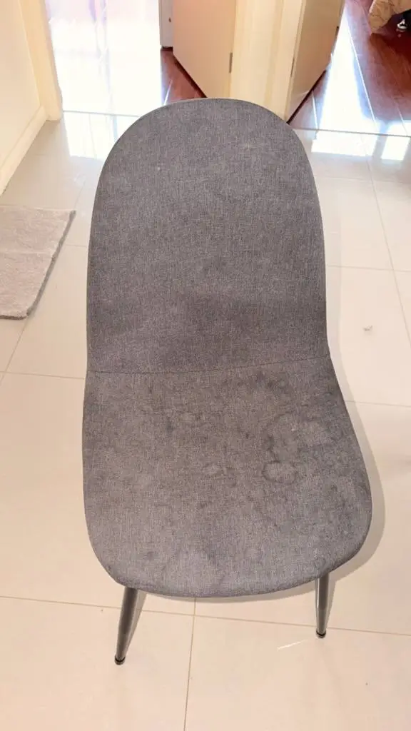 Stained grey fabric dining chair with visible watermarks before upholstery clean — before