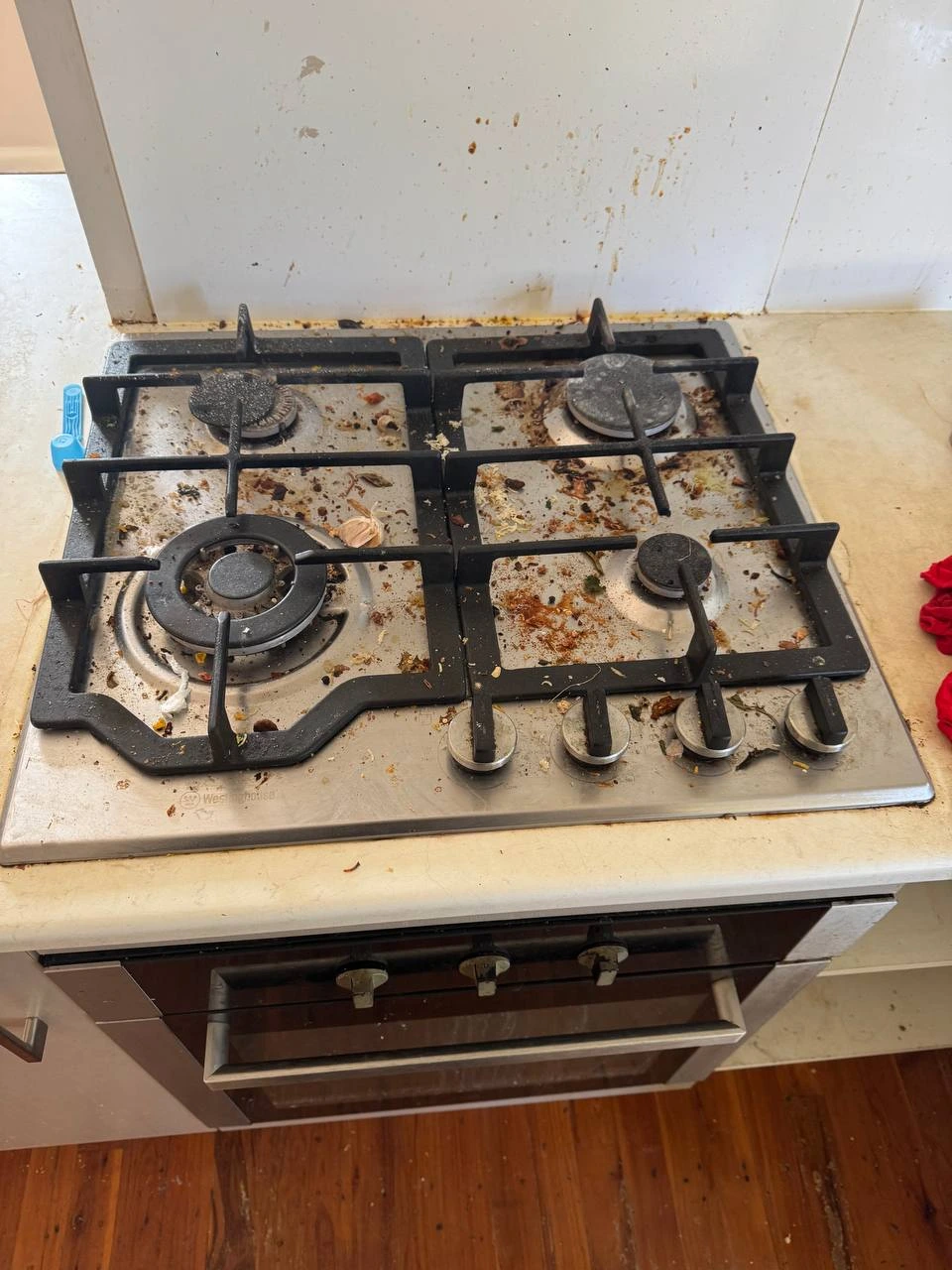 Dirty white gas cooktop with rust stains and grease before cleaning — before
